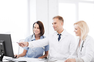 Image showing doctors looking at computer on meeting