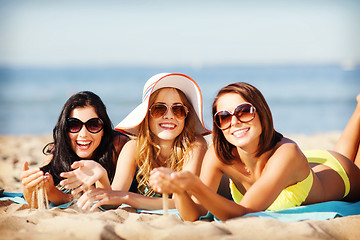 Image showing girls sunbathing on the beach