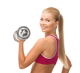 Image showing smiling woman with heavy steel dumbbell