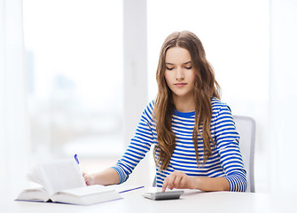 Image showing student girl with book, calculator and notebook