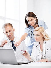 Image showing doctors looking at laptop on meeting