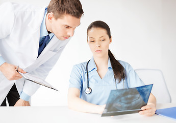 Image showing two medical workers looking at x-ray