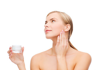 Image showing woman applying cream on her skin