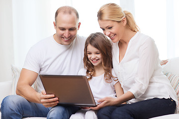 Image showing parents and little girl with laptop at home