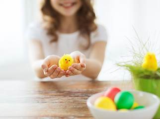 Image showing close up of girl holding yellow chiken toy