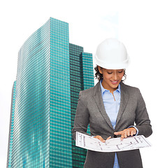 Image showing businesswoman in white helmet with blueprint