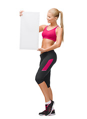 Image showing sportswoman with white blank board