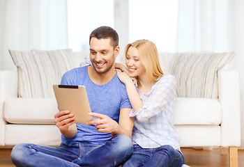 Image showing smiling happy couple with tablet pc at home