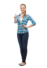 Image showing young woman in casual clothes showing thumbs up