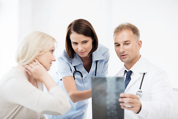 Image showing doctors with patient looking at x-ray