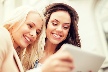 Image showing beautiful girls toursits looking into tablet pc