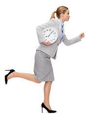 Image showing calm young businesswoman with clock running