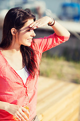 Image showing girl with drink on the beach