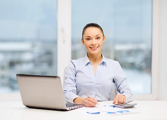 Image showing businesswoman working with documents in office