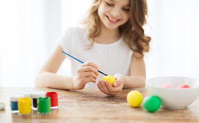 Image showing close up of girl coloring eggs for easter