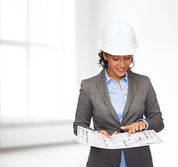 Image showing businesswoman in white helmet with blueprint