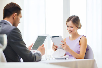 Image showing couple with menus on tablet pc at restaurant