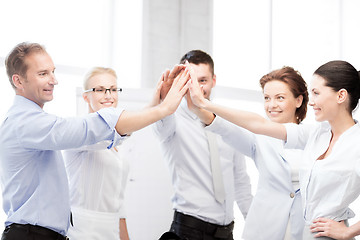 Image showing business team celebrating victory in office