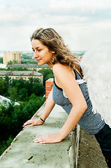 Image showing Attractive woman on roof