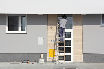 Image showing Worker on a ladder