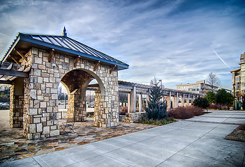 Image showing cultured stone terrace trellis details near park in a city 