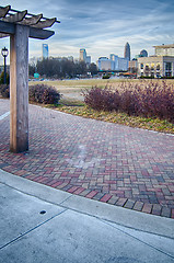 Image showing cultured stone terrace trellis details near park in a city 