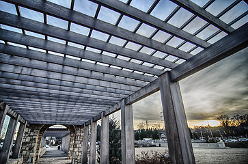 Image showing cultured stone terrace trellis details near park in a city 