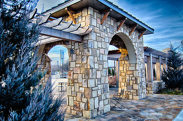 Image showing cultured stone terrace trellis details near park in a city 