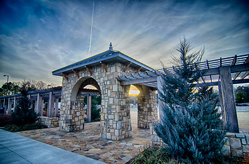 Image showing cultured stone terrace trellis details near park in a city 