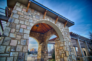 Image showing cultured stone terrace trellis details near park in a city 