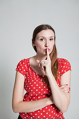 Image showing Attractive woman with finger over pursed lips