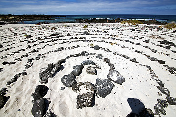Image showing spiral of black rocks in the white  beach   lanzarote spain