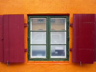 Image showing Colorful red shutters on a window.