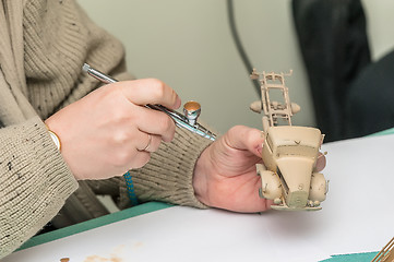 Image showing Man painting truck model