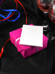 Image showing Two champagne glasses and red gift box