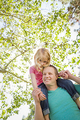 Image showing Cute Young Girl Rides Piggyback On Her Dads Shoulders