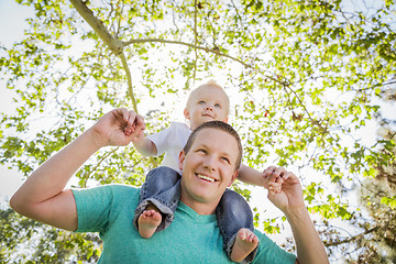 Image showing Cute Young Boy Rides Piggyback On His Dads Shoulders