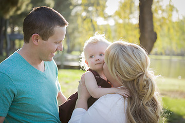 Image showing Cute Young Baby Boy Being Hugged By His Parents