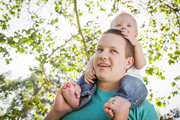 Image showing Cute Young Boy Rides Piggyback On His Dads Shoulders