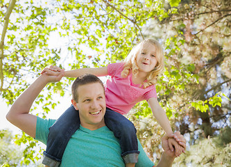 Image showing Cute Young Girl Rides Piggyback On Her Dads Shoulders