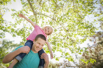 Image showing Cute Young Girl Rides Piggyback On Her Dads Shoulders