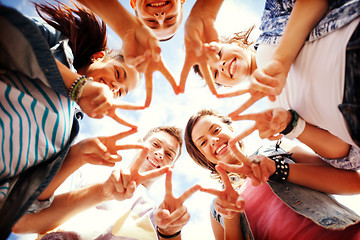 Image showing group of teenagers showing finger five