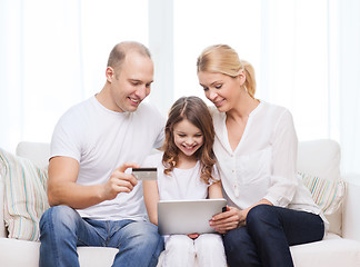 Image showing parents and girl with tablet pc and credit card