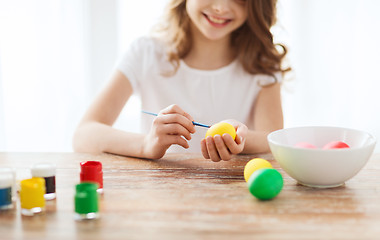 Image showing close up of girl coloring eggs for easter