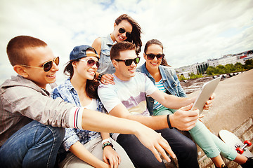 Image showing group of teenagers looking at tablet pc