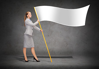 Image showing smiling woman holding flagpole with white flag