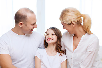 Image showing smiling parents and little girl at home