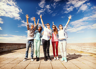 Image showing group of teenagers holding hands up