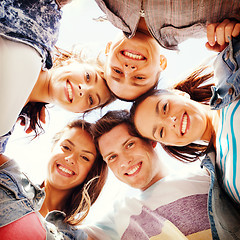 Image showing group of teenagers looking down