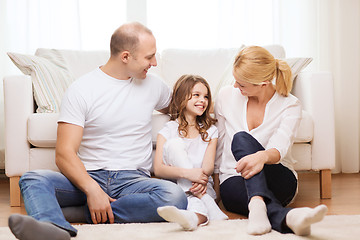 Image showing parents and little girl sitting on floor at home